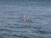  No, she is not asking for a help, but waiving to me.
